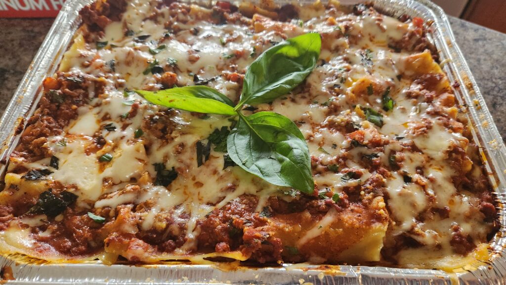 A delicious baked lasagna topped with melted cheese and fresh basil leaves.